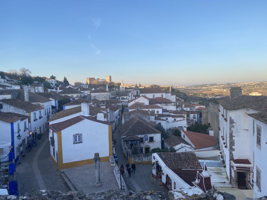 From Lisbon: Fátima, Batalha, Nazaré, and Obidos Tour by Van - Óbidos: cobblestones, castle walls, and ginjinha
