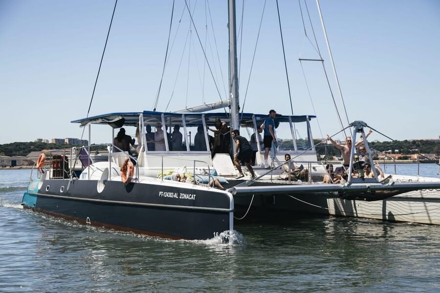 Lisbon: Catamaran Boat Party with Music, Open Bar & Dives - The open bar, music, and deck atmosphere