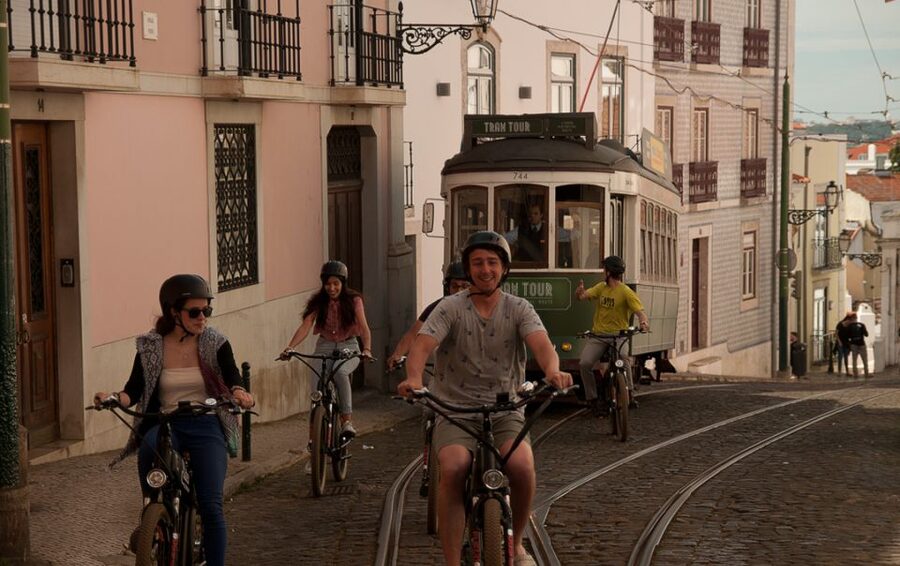 Lisbon: Hills, Alfama, and Mouraria Tour by Electric Bike - Alfama by bike, with the castle above you