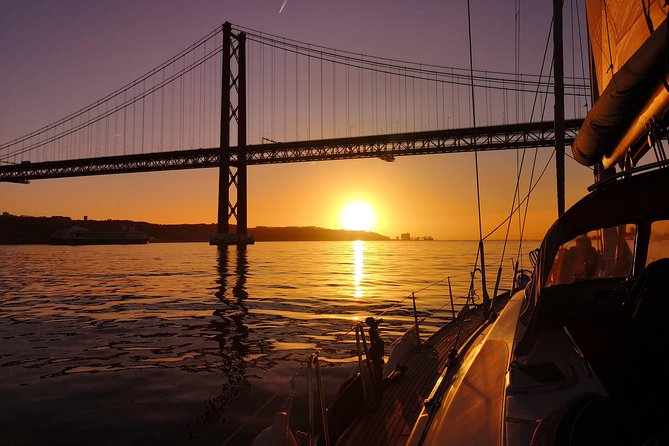 Lisbon Sunset Sailing Tour on Luxury Sailing Yacht with 2 Drinks - Under the 25th of April Bridge